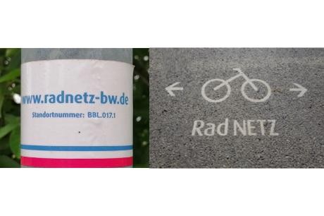 RadNETZ-Sticker auf einer Säule und auf dem Asphalt aufgebrachtes Fahrradsymbol und Schriftzug "RadNETZ"